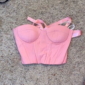 Pink corset, adjustable in the back and fits up to a C in cup size.